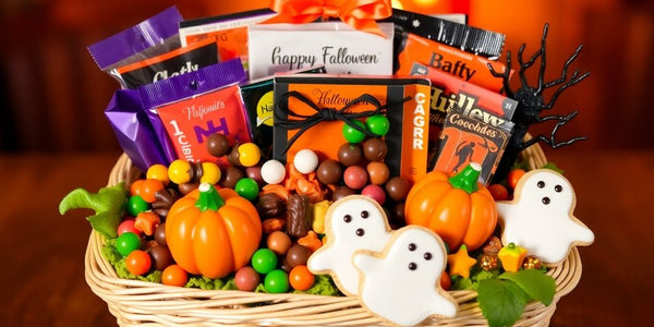 Halloween gift basket with candy and decorations.